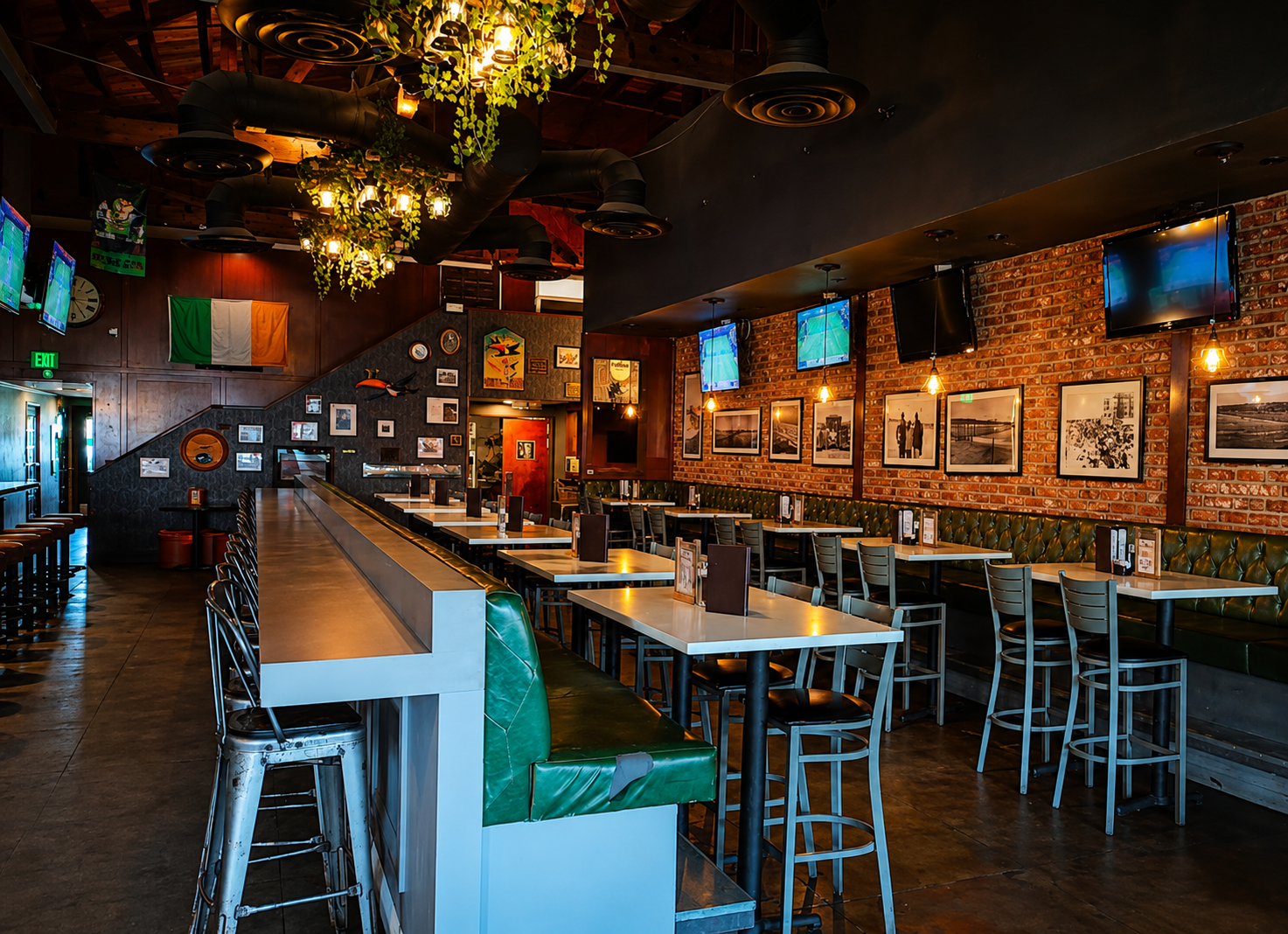 The main bar room with green leather booths, high-top tables and rows of televisions.
