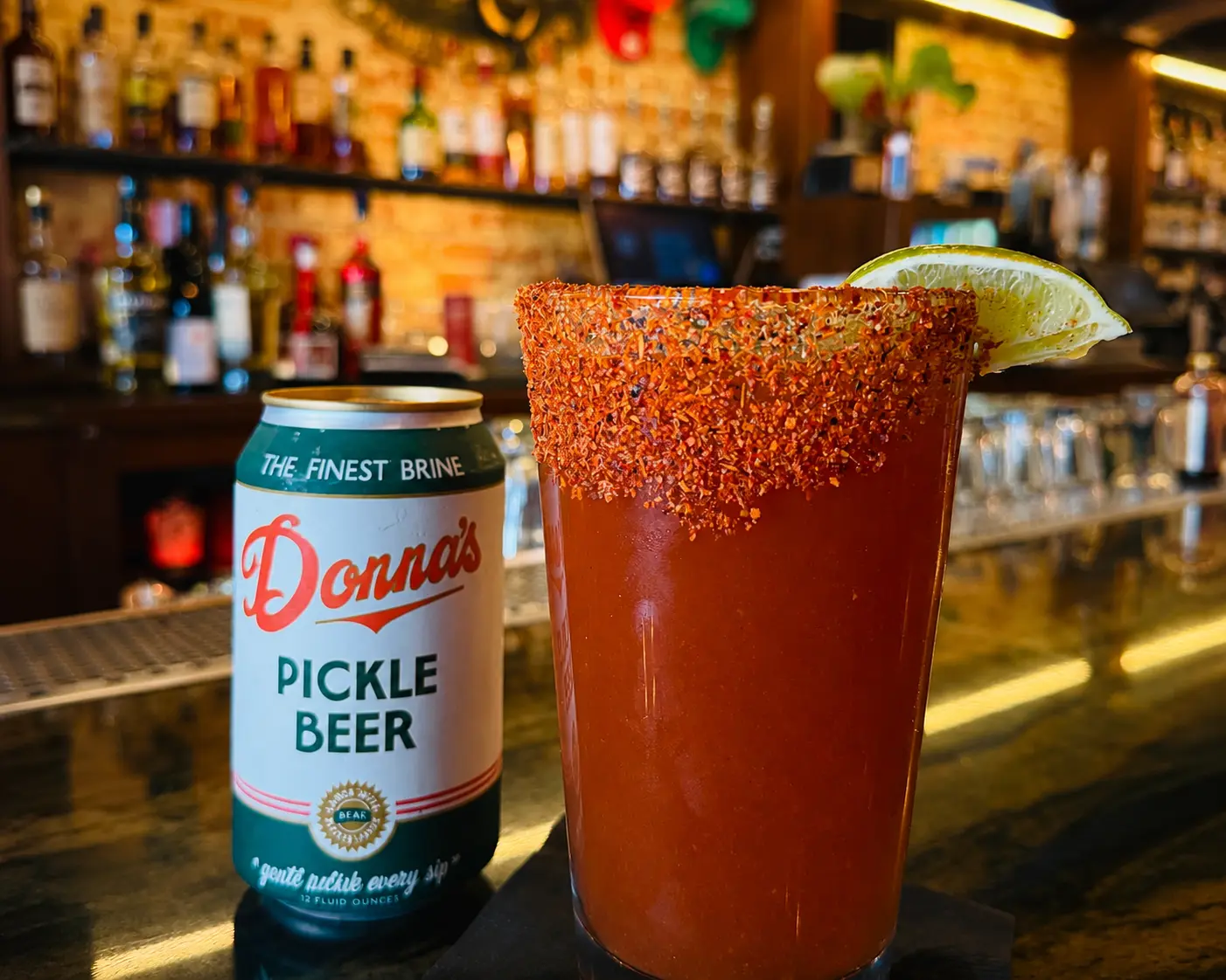 A garnished Bloody Mary with a celery stalk and lime on the bar at Patrick Molloy's.